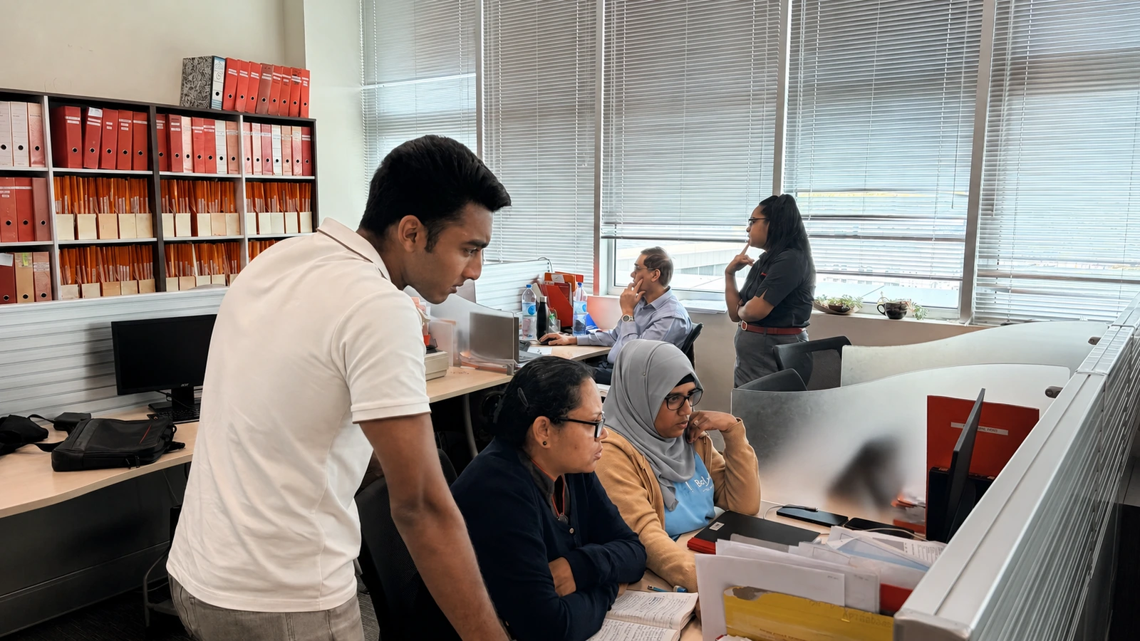 An Island AI consultant observes a work process with a team in their office.